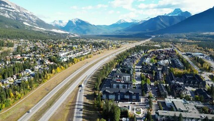 Wall Mural - Aerial view of Trans-Canada Highway (Highway 1) exit 89 to Downtown Canmore in Canadian Rockies in a autumn sunny day. Alberta, Canada. Transportation concept.