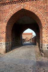 Canvas Print - medieval gate and walls made of stone and brick in the city of Neubrandenburg