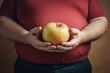 © Nitcharee - World Obesity day, Fat people hold apple , cholesterol .