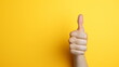 Close up photo of Woman hand thumb up with yellow background with Generative AI
