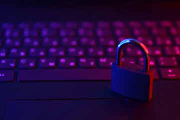 computer security concept with a closed padlock on the keyboard. padlock on top of a laptop keyboard