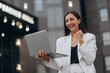 © MZaitsev - Happy excited successful businesswoman triumphing on city street.