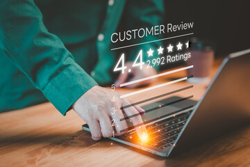 Fototapete - Customer using a computer laptop give ratings and point 4.4 stars icon for feedback review satisfaction service opinion and testimonial