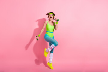 Wall Mural - Full length portrait of energetic astonished person arms hold dumbbells look empty space isolated on pink color background