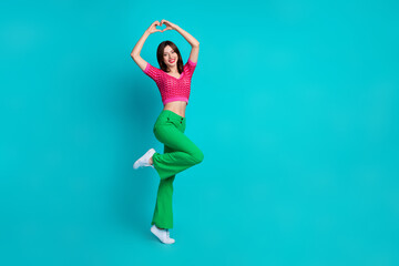 Poster - Full length photo of good mood lovely woman dressed knitwear top showing heart over head stand one leg isolated on blue color background