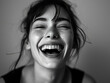 Joyful Young Woman Laughing with Closed Eyes in Monochrome