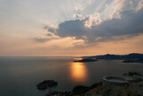 Fototapeta Zachód słońca - Orange sunset over the mountains and the island of Sveti Stefan. Montenegro