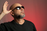 Fototapeta  - Caucasian, bald man in sunglasses, confident looking up.