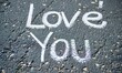 © simba kim - White chalk written words 'Love You' on the grey dark asphalt, ,Generative AI