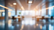 © Uranzaya - Blurred empty open space office. Abstract light bokeh at office interior background for design.
