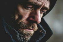 Male Depression And Loneliness. Close-up Of A Man's Face Suffering From A Despairing Feeling, Looking Down
