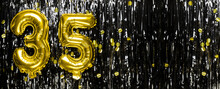 Gold Foil Balloon Number Number 35 On A Background Of Black Tinsel Decoration. Birthday Greeting Card, Inscription Thirty Five. Anniversary Event. Banner.