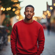Handsome Africans Americans man wearing a red blank crewneck sweatshirt. mock up style photo. background outside at charismas time