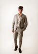 © theartofphoto - Full figure shot of handsome elegant young man with business suit, on white, looking at camera