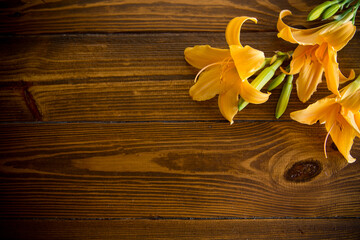 Wall Mural - bouquet of beautiful yellow lilies on wooden table