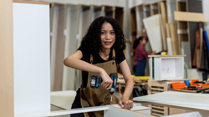 Carpenter working on woodworking machines in carpentry shop. Carpenter working to making wood furniture in wood workshop