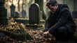 ©  Mohammad Xte - Christian man crying next to a grave with a headstone for a deceased relative in the family
