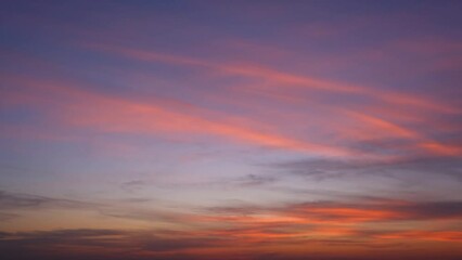 Wall Mural - Vibrant hues dance as the setting sun kisses the horizon, painting the sky with a rapid burst of fiery colors, while fluffy clouds gracefully morph in a mesmerizing fast-forward display. Timelapse.
