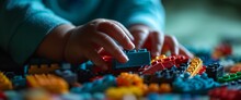 A Child's Hands Playing With A Blue And Red Lego Train Set Generative AI