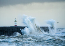 Lighthouse, Breakwater And Crashing Storm Waves At Newhaven