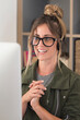 © simona - Happy adult young woman in video call conference at home in smart working free alternative office job lifestyle - pretty female people receive news on laptop computer and smile with joyful