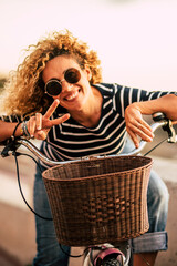 Wall Mural - Portrait of beautiful adult middle age woman smiling and having fun looking at the camera - female active people with bike and healthy lifestyle outdoor - cheerful mature enjoy spring and summer