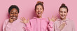 © WHstudio Leushin N - Photo of cheerful mixed race women smile happily exclaim from joy keep palms raised up react to something funny dressed in casual sweatshirt isolated over pink background. Multiracial female models