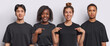 Cheerful young women point at themselves ask who me and show mock up space on t shirts for your logo stand near their boyfriends all dressed in black clothing isolated over white background.