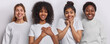 Horizontal image of cheerful mixed race young women look gladfully at camera press hands to heart feel thankful smile gladfully express positive emotions dressed in casual basic white clothes.
