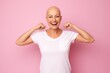 Woman with cancer without hair smiling on pink background. Cancer day concept