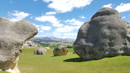 New zealand Elephant Rocks in Waitaki Valle sculptures green gras and blue sky