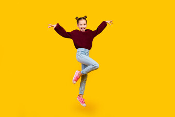 Sticker - Full length portrait of energetic overjoyed schoolchild jump empty space isolated on yellow color background