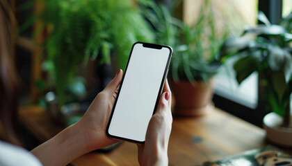 Close-up view of woman holding blank screen smartphone