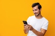 © SHOTPRIME STUDIO - Man cyberspace portrait communication space studio message yellow mobile phone happy technology copy phone smiling smartphone