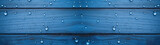 Fototapeta  - Closeup of single water drops in dark blue wooden wall background banner, abstract wood texture of raindrops