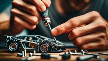 Hands Using A Precision Tool To Assemble A Miniature Car Model