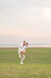© topntp - Happy young Asian couple in bride and groom clothing
