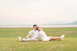 © topntp - Happy young Asian couple in bride and groom clothing