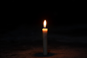 candles in the dark, flame of a candle burning in the dark