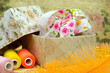 Box with braid and sewing items. Poster for interior. Colorful items for sewing and decoration close-up.