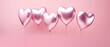Heart shaped air balloons isolated on pink pastel background in a love valentine concept.