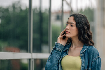 Wall Mural - urban young woman with phone on the street