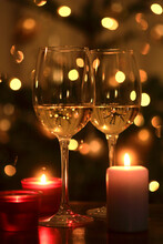 Burning Candles And Two Glasses Of White Wine