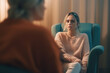 A middle-aged professional psychotherapist in the process of work. A woman at an appointment with an experienced psychologist, a psychiatry specialist, a psychological support session