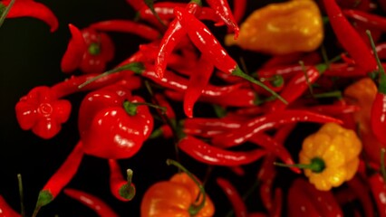 Aufkleber - Super slow motion of flying and rotating chilli peppers on black background. Filmed on high speed cinema camera, 1000 fps, placed on high speed cine bot, following the target.  Speed ramp effect.