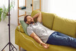 © Studio Romantic - Man lies on comfortable sofa under saline drip in modern private luxury hospital. Young satisfied Caucasian man rests lying under intravenous drip. Concept of healthcare and medicine.