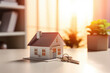 A mini house model and house keys, illustrating mortgage approval and home insurance concepts.