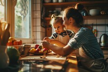 A Woman And Child Are Seated At A Kitchen Counter. This Image Can Be Used To Depict Family Bonding, Cooking, Or Mealtime Activities