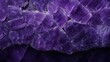 A close-up shot of a purple amethyst texture that is reflected in the light.