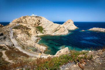 Canvas Print - The Famous Lighthouse Phare de la Pietra on the Rocky Island Ile de de la Pietra just outside L'Ile Rousse on Corsica, France